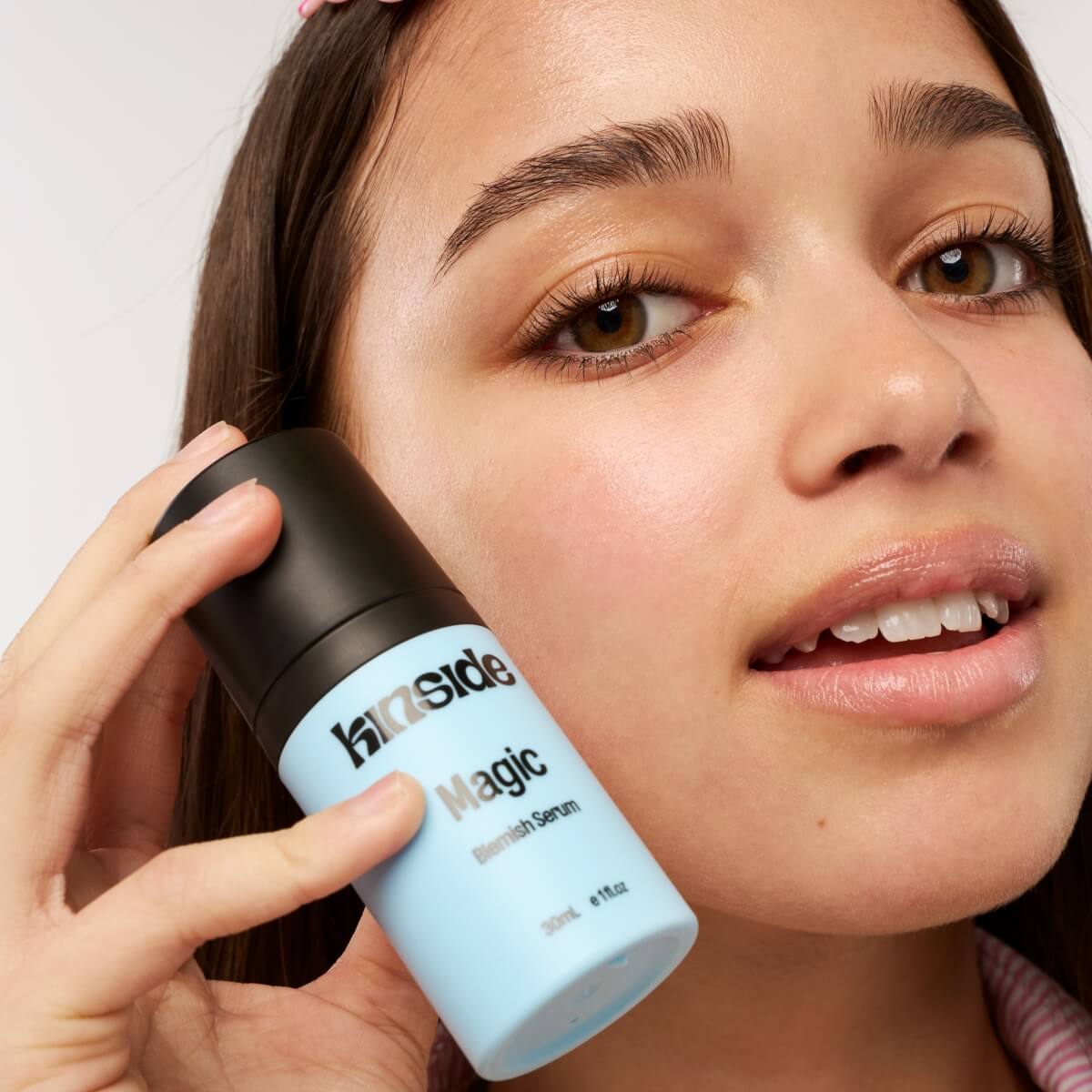 Teenager applying Kinside Magic Blemish Serum to skin