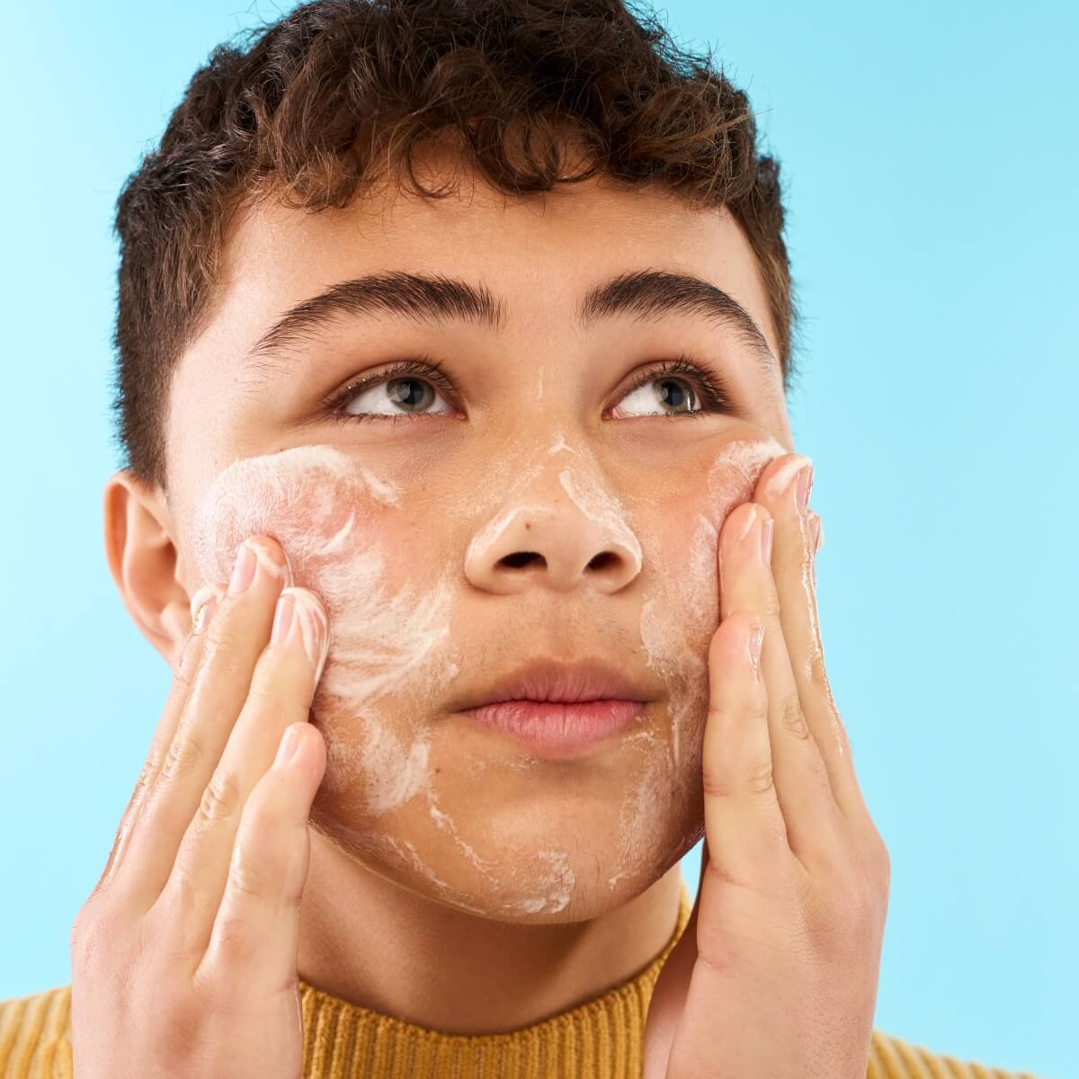 Teenager rinsing off Kinside Vibe Face Cleanser