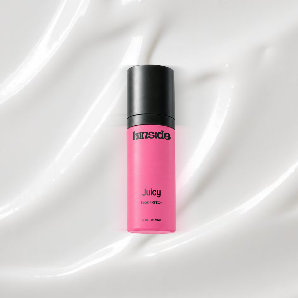 Juicy Face Hydrator bottle on a coloured background