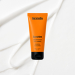 Sunshine Daily Defence SPF50+ sunscreen on a coloured background