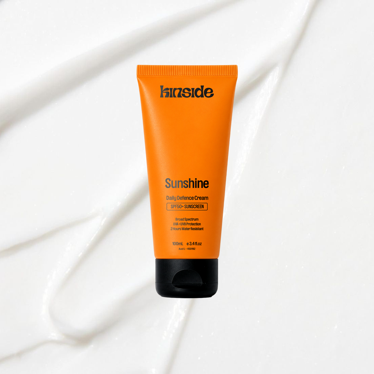 Sunshine Daily Defence SPF50+ sunscreen on a coloured background